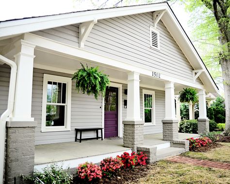 The front porch of the 1920's bungalow in Charlotte. Love the pop of color with the purple front door  #baystreetbungalows #houseflip #remodel #bungalow Bungalow Back Porch, Bungalow Exterior Colors Schemes, 1920s Bungalow Exterior, Craftsman With Enclosed Front Porch, Craftsman Bungalow Exterior Colors, Craftsman Bungalow Porch, Craftsman Style Front Porch, Traditional Exterior Craftsman 1920s, Bungalow Exterior Colors