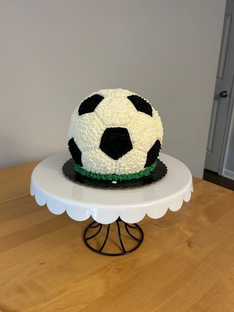 This is an all buttercream soccer ball smash cake for a 1st birthday party. I used the Wilton 6” Ball pan, but needed to create my own template to get the hexagons and pentagons the right size. Turned out super cute! Soccer Smash Cake, Soccer Theme First Birthday, Soccer 1st Birthday Baby Boy, Soccer First Birthday Party, Ball Cakes For Boys, Soccer Cakes For Boys, Soccer Party Cake, Ball Smash Cake, Soccer Cake Ideas For Boys