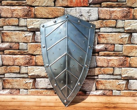 Embark on a journey through time with our exquisite Medieval Leaf Shield - an emblem of medieval elegance and strength. This armor knight shield, boasting a commanding size of 28 inches, is meticulously crafted from durable steel, offering not only a striking visual appeal but also a genuine connection to the age of chivalry. 🛡️ Impressive Size and Detail: At an expansive 28 inches, our Medieval Leaf Shield commands attention with its imposing size. The intricate leaf design, inspired by mediev Midevil Shields, Fantasy Shield, Shield Knight, Knight Armour, Warrior Shield, Knight Shield, Genuine Connection, Viking Shield, Creature Artwork