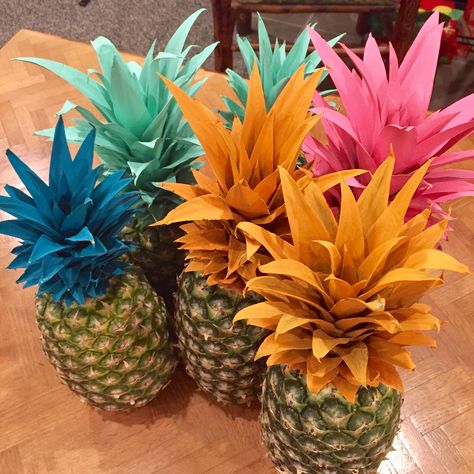 Vibrant painted pineapple centerpieces and decor Centerpieces With Pineapples, Pineapple Vases Centerpiece, Hawaiian Table Decorations Centerpieces, Painted Pineapple Centerpiece, Flamingo Party Centerpieces, Hawaiian Gala Theme, Pinapple Party Centerpieces, Pineapple Table Centerpiece, Tropical Cake Table Decor