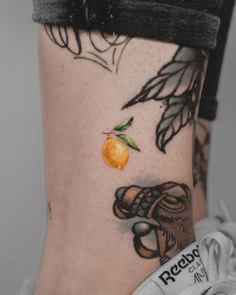 25 Amazing Lemon Tattoo Designs with Meanings and Ideas | Body Art Guru Yellow Ink Tattoo Healed, Lemon Tattoo Realistic, Lemon Tattoo Ideas, Lemon Tattoo Color, Citrus Fruit Tattoo, Lemon Lime Tattoo, Italian Lemon Tattoo, Lemons Tattoo, Lemon Flower Tattoo