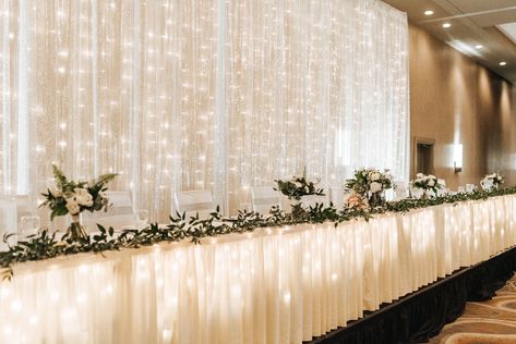 Behind Bridal Table Decorations, Head Table Backdrop Greenery, Wedding Head Table Decor Simple, Head Table With Bridesmaid Bouquets, Wedding Backdrop Behind Head Table, Lighted Backdrop Wedding, Bridal Table Backdrop Receptions, Large Head Table Wedding Decorations, Elegant Head Table Wedding