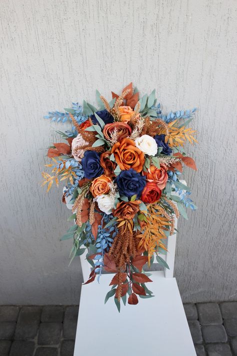 Embrace the beauty of Black Friday sale with rust navy wedding bouquet, a cascading masterpiece designed to adorn your fall wedding. With an enchanting blend of rust and navy, this bouquet captures the essence of the season, making it a perfect choice for your bridal needs. Dive into the elegance of bridal Black Friday to elevate your special day with this captivating bouquet that harmonizes the richness of autumn with timeless beauty. ○ Color: dusty blue, orange, beige, green ○ Personalization: I can make changes to your wishes ○ Processing time: 1 - 2 weeks ○ Shipping time: 7 - 14 business days NOTE  ○ I ship with REGISTERED mail and you will get a tracking number.  ○ All items will be carefully packed in special package materials.  ○ The actual color may differ slightly from the one you Royal Blue And Rust Wedding, Dusty Blue And Orange Bridesmaid Dresses, Blue And Copper Wedding Flowers, Fall Beach Wedding Flowers, Fall Wedding Blue And Green, Rust And Blue Wedding, Rust Navy Wedding, Terracotta And Dusty Blue Wedding, Orange And Blue Wedding Colors