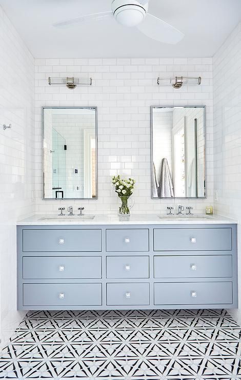 A light blue dual washstand accented with square glass knobs is fitted with a white quartz countertop holding his and hers sinks beneath polished nickel cross handle faucets. His And Hers Sinks, Interior Design Minimalist, Double Vanity Bathroom, Subway Tiles, Bathroom Trends, Upstairs Bathrooms, House Bathroom, Bathroom Remodel Master, Beautiful Bathrooms