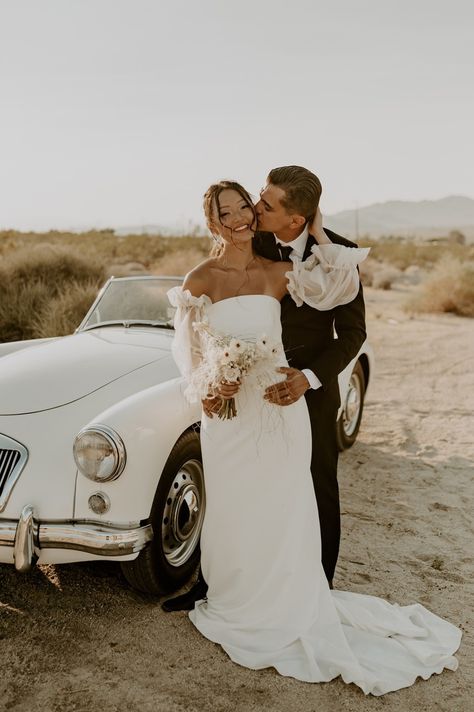 Classic-car-photoshoot-classic-car-desert-elopement-joshua-tree-wedding-puffy-sleeve-wedding-dress-black-and-white-tux-boho-elopement-joshua-tree-airbnb-joshua-tree-wedding-venue-neutral-floral-bouquet-invite-suite-flat-lay-joshua-tree-national-park-joshua-tree-engagement-desert-wedding-wedding-dresses-wedding-decor-wedding-invitations-mens-suit-bride-and-groom-photos Classic Car Wedding, Car Engagement Photos, Joshua Tree Airbnb, Classic Car Photoshoot, Alyssa Marie, Vintage Engagement Photos, Joshua Tree Engagement, Wedding Dress Black, Vintage Car Wedding