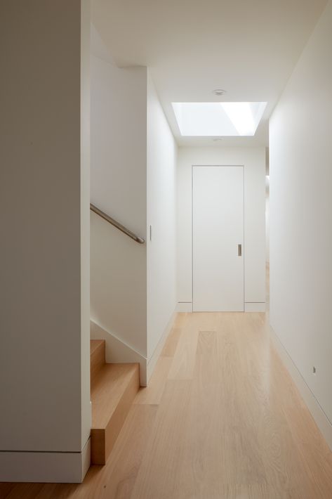 5 Colors to Paint Walls That Will Make an Entryway Look Bigger | Livingetc Recessed Baseboard, Make An Entryway, Minimalist Hallway, Modern Baseboards, Natural Oak Flooring, White Hallway, Skylight Design, Paint Walls, Build Home