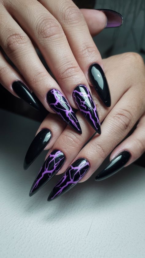 Channel your bold side with these striking stiletto nails! The sleek black background accentuates the eye-catching purple lightning pattern, creating a look that’s both fierce and fashionable. Perfect for Halloween or any time you want to make a statement! #acrylicnails #octobernails #nailsdesign #nailsinspo Purple Black Nails, Purple And Black Nails, Purple Stiletto Nails, Black And Purple Nails, Purple Nail Art Designs, Lightning Pattern, Purple Lightning, Ender Dragon, Purple Nail Art