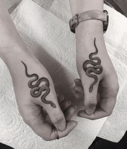 Snake Tattoo Designs & Meanings [2020 Guide] - Tattoo Stylist Snake Tattoo Ideas, Snake Tattoo Meaning, Small Snake Tattoo, Daisy Tattoo Designs, Thumb Tattoos, Black And White Snake, Snake Tattoos, Serpent Tattoo, Irish Tattoos