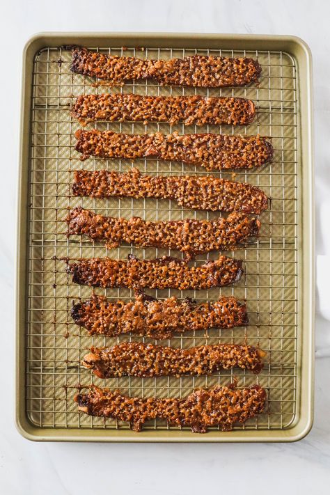 Praline Bacon | Looking for a show-stopping brunch recipe?  Look no further!  Here's the best blend of sweet, salty and slightly spicy, all wrapped up in everyone's favorite, bacon. Thick-cut bacon coated in a pecan-brown sugar crumble and roasted until sticky, caramelized and crisp.    #brunch #brunchrecipes #nevernothungry #bacon Praline Bacon Recipe, Praline Bacon, Not Hungry, Sugared Pecans, Brunch Recipe, Thick Cut Bacon, Candied Nuts, Bacon Recipes, Gifts For Coffee Lovers