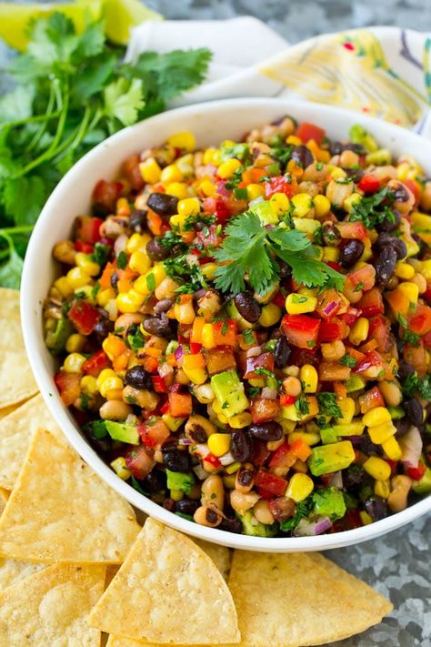 A bowl of cowboy caviar surrounded by tortilla chips. Cowboy Caviar Dip, Salty Side Dish, Caviar Recipes, Homemade Tortilla Chips, Cowboy Caviar, Clam Recipes, Dip Recipes Easy, Pea Salad, Homemade Tortillas