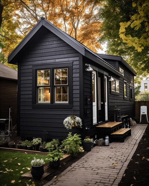 10 Striking Black Tiny Homes: The Pinnacle Of Modern Minimalism Mini Houses Tiny Homes, Tiny Home Exteriors, Small Black House, Tiny Home Interior Ideas, Black Tiny House, Small Modern Cottage, Black Small House, Tiny Cottage Floor Plans, Tiny Homes Interior