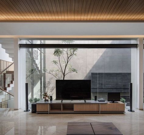 Tv Unit Between Two Windows, Rakta Studio, Glass Tv Unit, Interior Reference, 3 Storey House, West Facing House, Backdrop Tv, Hanging Tv, Timber Pergola