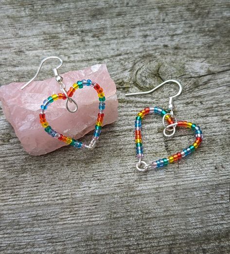 Made with Czech glass beads 💖 #earrings #heart #lgbt #yaoi #heartearrings #lgbtearrings #rainbow #rainbowearrings #y2k #y2kfashion #gayjewellery #gayjewelry #lgbtqaearrings #rainbowearrings #rainbowheartearrings Pride Jewellery Diy, Pride Earrings Diy, Rainbow Heart Beads Jewelry For Gift, Handmade Jewelry For Pride Gift, Pride Jewelry Earrings, Lgbtq Beaded Jewelry, Gay Jewelry, Pride Jewellery, Wire Wrapped Jewelry Tutorials