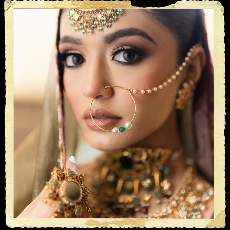 The intricate maang tikka, with its detailed gold work and delicate hanging pearls, graces her forehead, perfectly complemented by the large, ornate nath (nose ring) that adds a classic touch of elegance. Her neck is beautifully accentuated by a layered choker necklace, encrusted with a blend of precious stones and elaborate filigree designs, epitomizing luxury and grandeur. The look is completed with statement earrings, an opulent ring, and a pair of intricately designed bangles, all contrib... Wedding Nose Ring Brides, Nath Design, Bridal Nath, Nath Nose Ring, Bridal Nose Ring, Bridal Jewelry Sets Brides, Indoor Ideas, Rose Gold Bridesmaid, Soft Makeup Looks