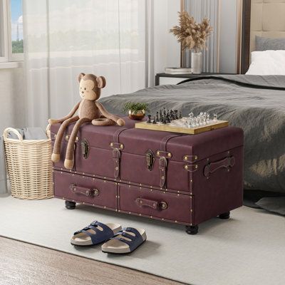 The storage trunk lid is hinged and lifted, with slightly rounded edges and decorative studded straps and rivets that add to the turn-of-the-century style, a striking decorative addition to your decor. The beautiful craftsmanship along with the vintage design makes it a perfect centerpiece in your room. features a wooden frame padded with faux leather outlined with rivets and filled with a sponge on top, which makes the storage trunk solid, stable, durable, comfortable, and beautiful. It has two Shabby Chic Trunk, Chest Cabinet, Leather Storage Ottoman, Vintage Trunks, Upholstered Storage Bench, Storage Trunk, Storage Ottoman Bench, Vintage Storage, Upholstered Storage