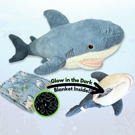 Meet Finn -- the Shark stuffed animal with a detachable glow-in-the-dark shark blanket that velcros and stores inside!  Finn the Shark is a uniquely charming plush toy featuring a delightful surprise--a 60" x 40" glow-in-the-dark shark-themed blanket tucked inside. Crafted with the softest materials, Finn promises a cozy embrace for little ones, offering a comforting companion for both playtime adventures and peaceful nights of sleep. The hand-designed blanket even detaches via velcro for easy machine wash. Expose the blanket to sunlight or bright light for 15-30 minutes to bring the glowing sharks to life! Sizing: 29" Plush with 60" x 40" Blanket Blanket Buddies is a US veteran-owned small business.  Thank you for choosing a Blanket Buddies product! Sea Creatures Plushies, Stuffed Sea Animals, Shark Build A Bear, Ocean Animal Plushies, Shark Gift Ideas, Shark Plushies, Shark Toys, Shark Stuffed Animal, Shark Blanket