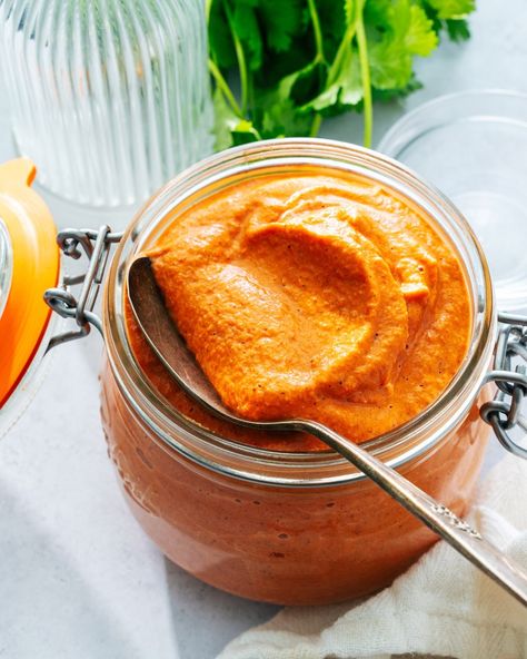 This romesco sauce recipe is a bright red, zingy Spanish condiment with loads of flavor! Serve with vegetables, fish, and more. #romesco #romescosauce #romescosaucerecipe Fresno Peppers, Romesco Sauce Recipe, Romesco Sauce, Sherry Vinegar, Vegan Sauces, Easy Dinners, Crushed Tomatoes, Vegan Paleo, Smoked Paprika