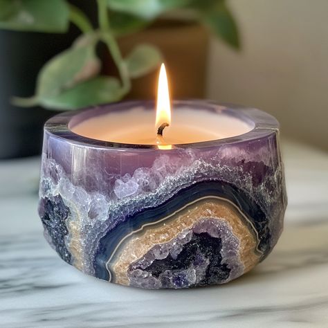 The Geode Candle is a stunning, nature-inspired piece that combines the beauty of crystals with the warmth of candlelight. Shaped like a real geode, the outer surface mimics the rugged texture of stone, while the inside reveals intricate, crystal-like formations that sparkle when illuminated. Hand-poured with premium, long-lasting wax, each candle boasts a unique, gemstone-like appearance, offering a blend of art and ambiance. As the candle burns, it casts a soft, radiant glow, creating a soo... Geode Candle, Decor Market, Diy Candles Scented, Light Filters, Stunning Nature, Stone World, Elegant Home, Unique Candles, Elegant Home Decor