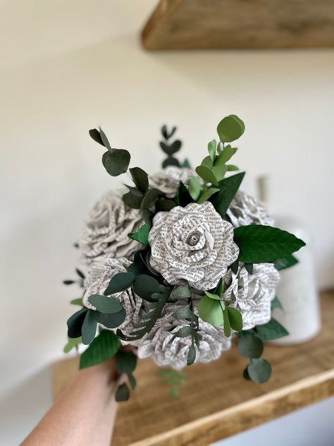 A beautiful bouquet of book page flowers and paper foliage. Perfect for a bridal bouquet or to celebrate a special occasion for home display.  Two sizes of flowers made from random book pages and stems of foliage shapes made using various shades of green textured papers. If you prefer to exclude any of the green shades from the bouquet just let me know. This bouquet is made by me, by hand - every petal, every leaf, every stem. Standard ribbon wrap options available from hessian to double satin r Book Paper Flowers Bouquet, Paper Flowers With Book Pages, Book Paper Bouquet, Book Page Wedding Bouquet, Paper Leaves For Bouquet, Book Bouquet Wedding, Book Page Bouquet, Paper Book Flowers, Book Flower Bouquet