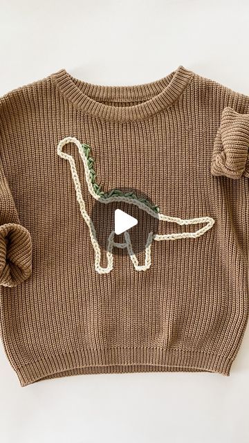 Sarah - DIY Embroidery Kits & Patterns on Instagram: "Made this sweater for my little boy! I don’t think I ever shared how I got the Dino pattern onto the sweater. Basically I drew a Dino and then cut it out creating a stencil of sorts. Then I traced it onto the sweater 🦕   If you want to learn to embroider on a sweater, comment “sweater stitch along” and I’ll DM you the link for my virtual class. It  will teach you how to make one of those cute name sweaters using a pattern that’s says “hello” - but you could totally take what you learn and embroider a dinosaur or flower or whatever you want 🫶🏻" Little Boy Embroidery Ideas, Boys Embroidered Sweater, Sweater Embroidery Diy, Racoon Embroidery, Boy Embroidery Ideas, Boys Embroidery Designs, Sweater Embroidery Ideas, Embroidery For Boys, Embroidery Sweater Diy