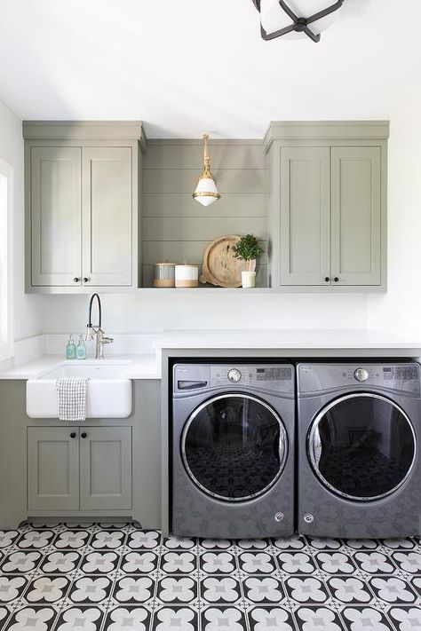 A silver front loading washer and dryer is placed on white and gray mosaic floor tiles and enclosed beneath a white countertop. Kate Marker Interiors, Green Laundry, Room Storage Diy, Basement Laundry, Laundry Room Renovation, Laundry Room Shelves, Laundry Room Cabinets, Laundry Room Remodel, Laundry Room Inspiration