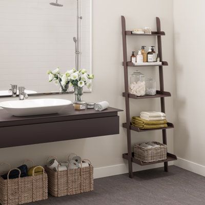 This leaning wooden bookshelf can be used for storing, displaying, organizing, or other indoor uses. Our 5-tier leaning ladder-style shelf has a trendy yet timeless style that can be used to organize your home office, neatly store towels and toiletries in a bathroom, display photos in your living room or keep kitchen supplies easily accessible. This angled shelf has a lightweight design and can lean against wall surfaces. The modern ladder bookcase is designed in a contemporary, minimalist, mode Bathroom Ladder Decor, Bathroom Ladder Shelf, Bathroom Display, Wooden Ladder Shelf, Leaning Shelf, Living Room Wall Designs, Leaning Ladder, Wooden Bookshelf, Shelf Decor Living Room