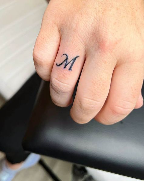 76 Hand Tattoos For Women with Meaning - Our Mindful Life W Finger Tattoo, Finger Font Tattoo, Tattoo Ideas Small Finger, Small M Tattoo, M Tattoo Design, Finger Tattoo Letter, M Letter Tattoo, Meaningful Finger Tattoos, Finger Letter Tattoos