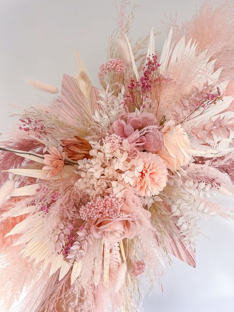 This dried flower decoration includes all the shades of light pink pampas and would be the perfect addition to your baby girls nursery, your salon, in your home or for your wedding! It consists of different shades of light pink fluffy pampas, dried, preserved and artificial flowers and is totally customisable so if you would like to tweak the size or colour please message me and I will be happy to help 😊  It is really easy to install. 2x strong adhesive hooks will be supplied with it which you stick to the wall and hook onto the back of the piece. Size mini = 50cm wide Size medium = 70cm wide  Size large = 90cm wide  The piece in the photo is medium. Please message me if you are requiring it urgently and I will see what I can do. Everything I make is handmade and therefore no two pieces a Pink Pampas Wall Decor, Pink Boho Centerpieces, Pink Boho Wedding Decor, Pink Pampas Grass Decor, Pampas Wall Decor, Pink Flower Decor, Pampas Wall, Pampas Decor, Pink Boho Wedding