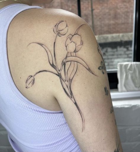 Tulip tattoo inspo Tulip Line Work Tattoo, Tulip Shoulder Tattoos For Women, Ornamental Tulip Tattoo, Spine Tattoos For Women Tulips, Tulip Tattoo Collar Bone, Tulip Tattoo Thigh, Tulip Bouquet Tattoo Design, Tulip Tattoo Shoulder, Flower Back Arm Tattoo