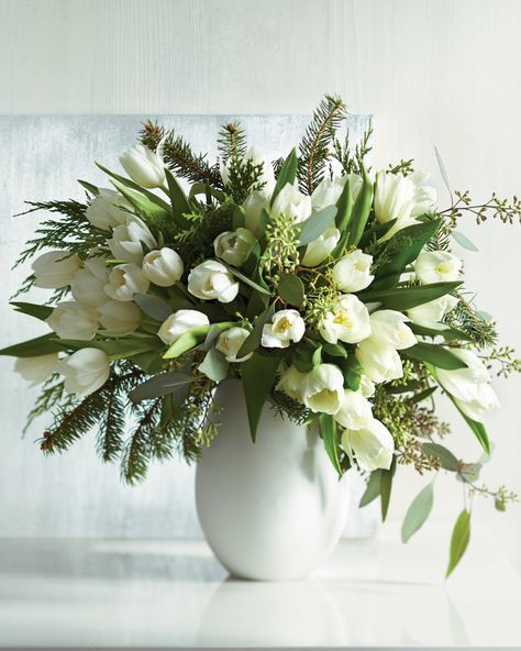 Conjure dreams of a snowy, white Christmas with this timeless tulip, eucalyptus, and Douglas fir centerpiece -- any time of the year! Tulpen Arrangements, Winter Floral Arrangements, Fresh Tulips, White Flower Arrangements, Tulips Arrangement, Spring Flower Arrangements, Winter Centerpieces, Silk Flower Arrangements, White Tulips