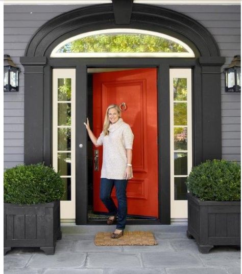 Grey siding with black trim, white accent and red/orange door, and large time walk way, cool lights and bushes. Front Door Planters, Orange Front Doors, Mixing Paint Colors, Door Planter, Red Front Door, Orange Door, Black Shutters, Grey Houses, Exterior Paint Colors For House