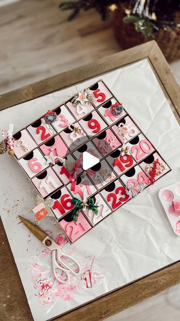 JAMIE THORPE | HOME DECOR | COASTAL LIVING | SHOPPING FINDS on Instagram: "DIY ADVENT CALENDAR 🎅🏽🎄🎁✨ SAVE AND SHARE THIS POST TO MAKE YOUR OWN.   WHAT YOU NEED I grabbed this cardboard advent calendar, and 5 packs of wooden numbers from Hobby Lobby plus acrylic paint (colors listed below)   ACRYLIC PAINT COLORS Here are the exact colors I used: (From Hobby Lobby) Folk Art “Ivory white” Folk Art “Baby Pink” Crafter Collection “Princess pink” Crafter Collection “Pink” Crafter Collection “Christmas Red” *Don’t forget the paint brushes.  WHAT I PUT INSIDE I added little hand written notes in the boxes. Each day with clues on them telling where to go find a fun Christmas themed surprise and a bible verse. Every other day I put a small piece of candy  DECORATE IT To decorate it, I only bough Advent Calendar Home Made, Paint Your Own Advent Calendar, Diy Wooden Advent Calendar, Ribbon Clothes, Hand Written Notes, Old Christmas Cards, Acrylic Paint Colors, Advent Box, Wooden Advent Calendar