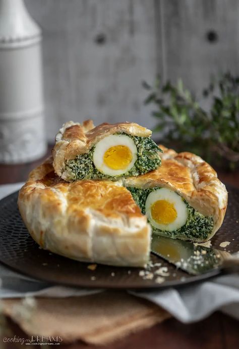 Torta Pasqualina is a traditional Easter Spinach and Ricotta quiche from Northern Italy. It's made with creamy ricotta and spinach filling, with hard-boiled eggs inside and a golden puff pastry crust on top. The recipe has ancient origins but it has been adapted for modern times and each family has its own variations with different types of greens and cheeses. Spinach Ricotta Pie, Italian Easter Pie, Spinach Eggs, Ricotta Pie, Easter Pie, Egg Pie, Puff Pastry Crust, Italian Easter, Easter 2024