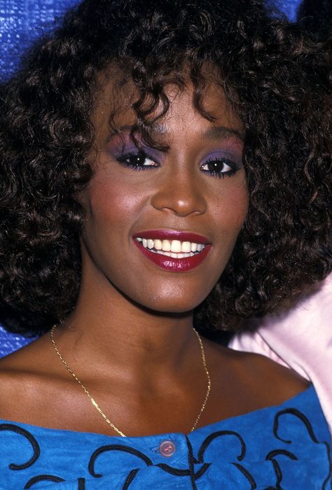 The '70s were all about pastels and the '90s featured tons of blue, but in the 1980s women wore lots of bold purples and pinks. By far the most flattering eyeshadow trend, it contrasts with all eye colors to make your irises stand out.  - GoodHousekeeping.com Black 80s Makeup, Whitney Houston Makeup, 1980s Black Hairstyles, 1980's Hair, 80s Hair And Makeup, 1980s Makeup And Hair, 80s Makeup Looks, 80s Things, 80s Hair Styles