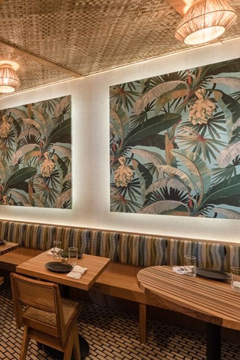 The banquette has a striped upholstery pattern and wallpaper above that reminisces the tropical fauna of the region.Image Credits – Will Ellis Tropical Cafe, Restaurant Banquette, Cafe Wallpaper, Upholstery Pattern, Vijay Kumar, Hotel Indigo, Striped Upholstery, Indian Restaurant, Michelin Star