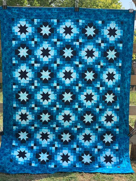 "This is a Twinkling Stars quilt done in teals using the boundless blenders botanical fabric.  This pattern is designed by Monique Dillard/ Opengate.   Different shades of teals to include fabrics from very light to dark.  It has a beautiful teal print fabric for the border.  The backing is a beautiful teal fabric that is on the front as well.  It was quilted on my domestic machine in squares and then every center star is free motioned and the area around this.  It is a beautiful quilt.    *This quilt is approximately 70\" wide by 93\" long.     *All fabric used is cotton.    *The batting used is Pellon Natural Cotton Batting.   *This item has been prewashed.   *If you want close-up pics just let me know and I'll send them to you.  If you have any questions, please ask. *No special washing Teal Quilt, Botanical Fabric, Comforter Blanket, Mountain Quilts, Stars Quilt, Twinkling Stars, Quilt Comforter, Grey Quilt, Teal Fabric