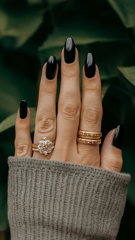 Elevate your style with these classy almond-shaped black nails, an embodiment of sophistication and modern flair. The sleek design offers a polished finish that complements any outfit, making them perfect for a chic evening out or a refined daytime look. Embrace the allure of simplicity and let your nails make a statement of elegant confidence. 💅🌟 Bridesmaid Black Nails, Plain Black Almond Nails, Matte Black Nails Almond, Black Engagement Nails, Classy Black Nail Designs, Dark Moody Nails, Almond Black Nails, Black And Chrome Nails, Black Nails Almond