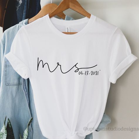 Personalise this Mrs. Shirt and make it the perfect tee for any occasion! Perfect bridal shower shirt, honeymoon shirt, or engagement gift! We also have a matching Mr. shirt to make the ideal couples mr. and mrs. shirts outfit! ♥ABOUT OUR TEES: Uptown Studio Designs uses premium unisex eco-friendly Bella canvas tees. The modern unisex cut is fitted and flattering for both men and women. These fitted tees are soft and lightweight with the right amount of stretch. Consider ordering your regular si Mrs Established Shirt, Mrs Shirts Brides, Mrs Shirt Ideas, Bride T Shirt Ideas, Bridal Shower Tshirt Ideas, Wedding Reception Outfit For Bride Comfy, Bride Tshirt Ideas, Bride Shirt Ideas, Bride To Be Shirts