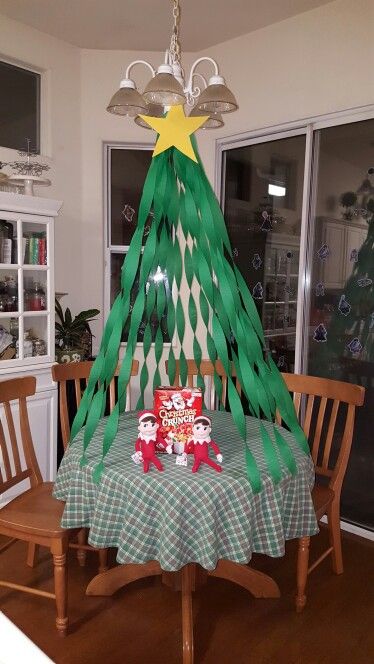 Elf on the shelf. Kitchen table Christmas tree. Crepe paper Christmas tree. Christmas crunch cereal. Elf breakfast. #elfontheshelf Crepe Paper Christmas Tree, Crepe Paper Christmas, Elf On The Shelves, Table Christmas Tree, Kindness Elves, Elf Ideas Easy, Elf Games, Elf Magic, Awesome Elf On The Shelf Ideas