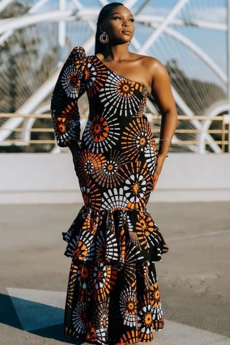 A lady wearing an  long ankara gown Trending Ankara Gowns, African Long Dress, Dinner Wears, African Glamour, Afro Design, Long Dress African, Styles For Summer, Ankara Long Gown Styles, African Outfits