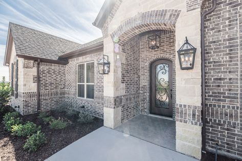 Brick color is Sheltered Bluff by Boral with buff mortar.  Stone is Gray Leuders with buff mortar.  Roof is Tamko Rustic Black.   Exterior trim and garage door color is Sable SW6083. Exterior stain is New Ebony. #swcolorlove Gray And Black Brick House Exterior, Brick And Rock Exterior Combinations, Stone Brick House Exterior, Gray Brick Exterior, Rustic Brick House Exterior, Gray Brick House Exterior, Brick And Stone House Exterior, Brick And Stone Exterior Combinations, Garage Door Colors