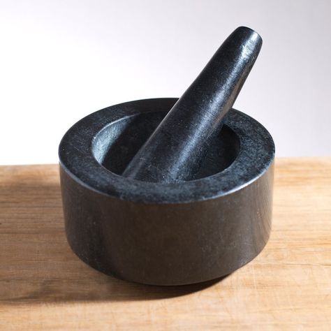 Black granite mortar and pestle from Simon Pearce | Remodelista Simon Pearce, Mortar Pestle, Natural Granite, How To Make Pesto, Kitchen Things, Spice Grinder, Granite Stone, Kitchen Helper, Black Granite