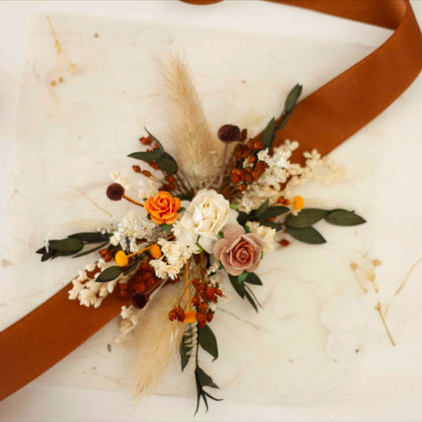 Elevate your autumn wedding with our exquisite boutonniere and corsage set, designed to
bring a touch of boho elegance to your special day. This beautifully crafted set is perfect for
adding a sophisticated and charming touch to both your bridesmaids and groomsmen. Each
piece is carefully made to complement the warm, rich tones of the autumn season, ensuring a
coordinated and stylish look for all. Fall Corsage, Boutonniere And Corsage, Fall Boutonnieres, Wedding Corsages, High School Dance, Bridesmaids Groomsmen, Wedding Boutonniere, Corsage And Boutonniere, Corsage Wedding