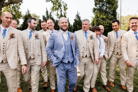 Groom wearing a blue linen suit whit white tie and pampas grass boutonniere. The groomsmen wore tan suits with blue ties and matching boutonnieres for this The Cordelle wedding in Nashville, TN | John Myers Photography & Videography Light Blue Bridesmaid Tan Groomsmen, Tan Suit With Blue Tie, Beige Suit Blue Tie, Blue And Tan Groomsmen, Tan Suits Groomsmen, Blue And Tan Wedding Party, Powder Blue Groomsmen, Tan Suit Groomsmen, Pampas Grass Boutonniere