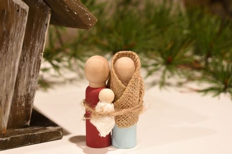 During this time of year, many display nativity scenes in celebration of Jesus' birth. These miniature nativity figures of Joseph, Mary, and baby Jesus are not only fun to make and play with, but they are a great visual reminder of the reason we celebrate!     What You'll Need  Two 3" peg people and one 1" peg person ( Simple Peg Doll Nativity, Wood Peg Nativity, Nativities To Make, Peg Nativity Set, Nativity Figures Diy, Diy Manger Nativity, Diy Wooden Nativity, Baby Jesus Craft, Nativity Peg Doll