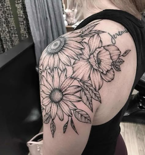 Shoulder wrapped tattoo large black and grey shading sunflower daisy and daffodil Daisy Tattoo Shoulder Cap, Different Tattoo Shading Styles, Sunflower Tattoo Sleeve Shoulder, Daffodil And Sunflower Tattoo, Daisy Shoulder Tattoos For Women, Lilly Tattoo Shoulder, Daisy And Daffodil Tattoo, Sunflower Shoulder Tattoos For Women, Sunflower And Daisy Tattoo