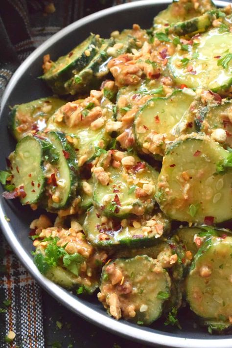 Fresh cucumbers are sliced and tossed in a quick and easy homemade nutty, salty, creamy, spicy, and garlicky sauce.  Toasting the peanuts first and combining them with peanut butter, soy sauce, and rice vinegar makes a delicious cold side, salad, or snack.  Serve at room temperature immediately after preparing for the best results! Spicy Peanut Sauce, Cold Side, Cucumber Recipes Salad, Spicy Peanuts, Cucumber Recipes, Salad Side Dishes, Pork Dishes, Cucumber Salad, Fresh Salads