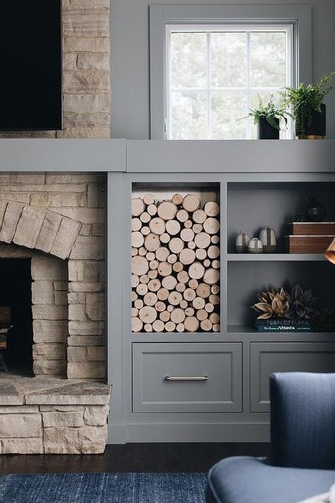 A TV is mounted over a rustic stone fireplace positioned beside gray built-in cabinets positioned under a wood cubby and gray styled shelves. Grey Stone Fireplace, Painted Built Ins, Rustic Stone Fireplace, Fireplace Design Ideas, Built In Around Fireplace, White Brick Fireplace, Painted Brick Fireplace, Built In Shelves Living Room, Living Room Built Ins