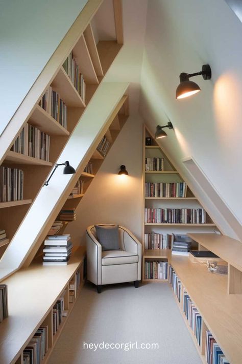 35 Beautiful Attic Library Ideas For Your Home - Hey Decor Girl [Latest Trending Decor Design Ideas] Attic Room Shelves, Angled Bookshelf Wall, Slanted Wall Bookshelf, Home Office Sloped Ceiling, Attic Library Sloped Ceiling, Loft Library Ideas, Attic Library Ideas, Attic Bookshelves, Sloped Ceiling Ideas