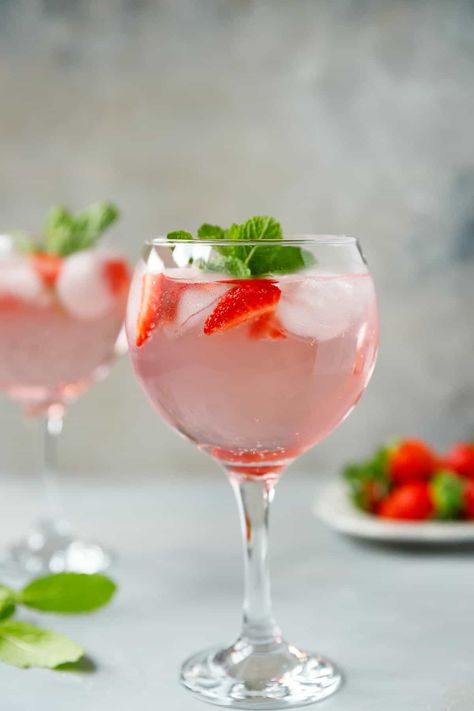 Strawberry Gin And Tonic - a sweet and refreshing cocktail made with fresh strawberries, pink gin, tonic water and ice. Perfect for parties and celebrations. Quick and easy to make, festive with an Strawberry Gin And Tonic, Popular Summer Cocktails, Pink Gin Cocktails, Strawberry Gin, Strawberry Cocktails, Tonic Drink, Refreshing Cocktail, Strawberry Mint, Pink Gin